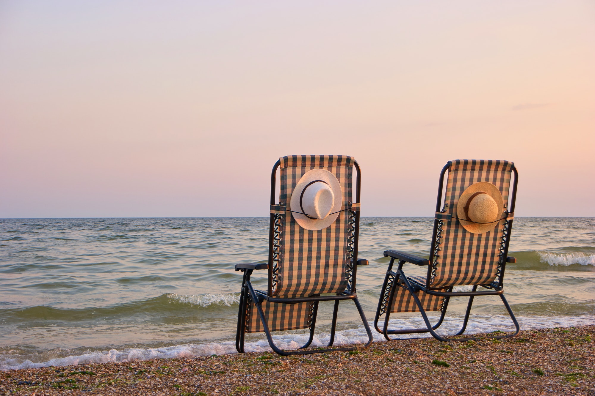 Deck chairs on a beach.